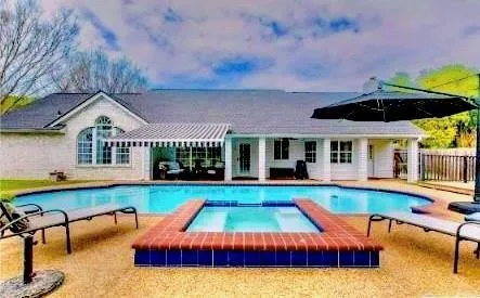 a view of a house with swimming pool and deck
