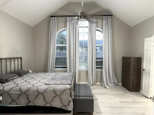 a bedroom with a bed and a mirror