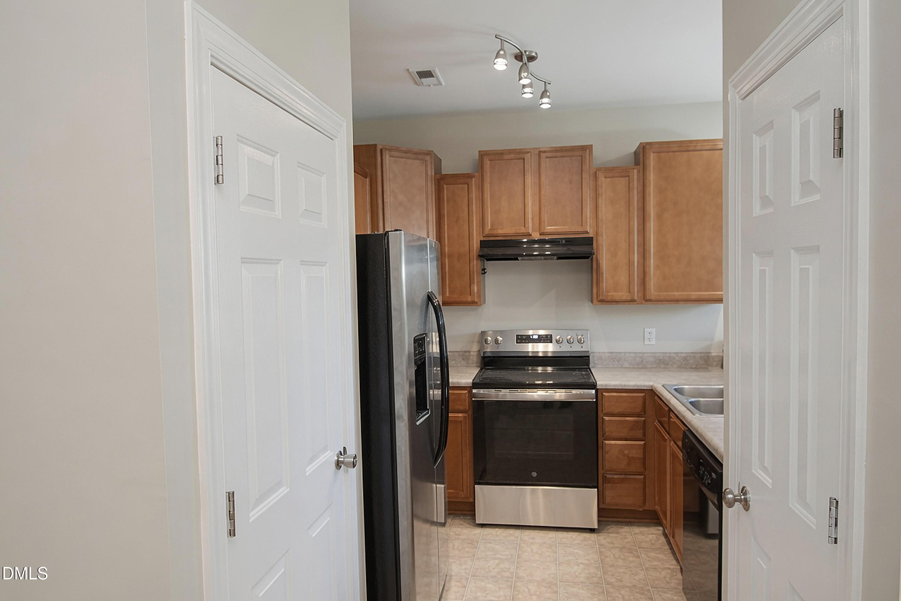 4809 Landover Pine Place Raleigh, NC 27616 - Photo 4 of 14 a kitchen with a refrigerator and a stove