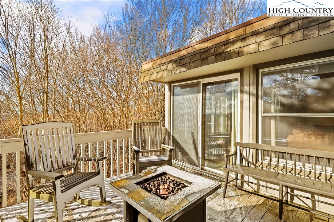 207 Pinnacle Ridge Road Beech Mountain, NC 28604 - Photo 22 of 48 a view of a balcony with wooden floor and outdoor seating