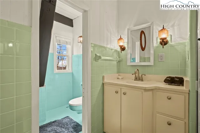 a bathroom with a toilet and a shower curtain