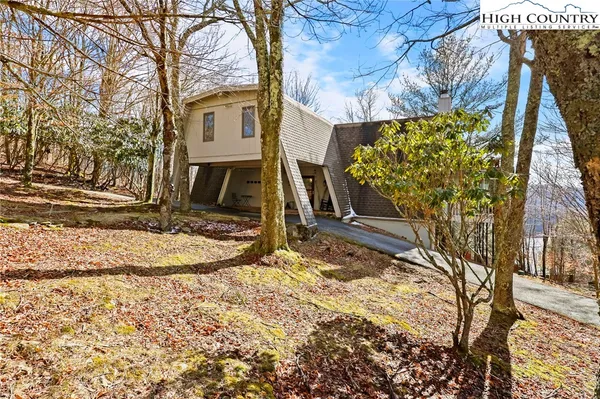 a view of a house with a yard covered with snow