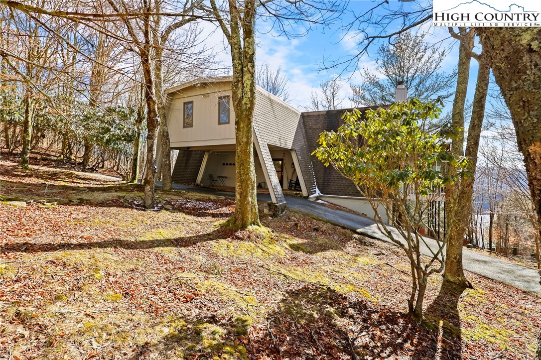 207 Pinnacle Ridge Road Beech Mountain, NC 28604 - Photo 3 of 48 a view of a house with a yard covered with snow