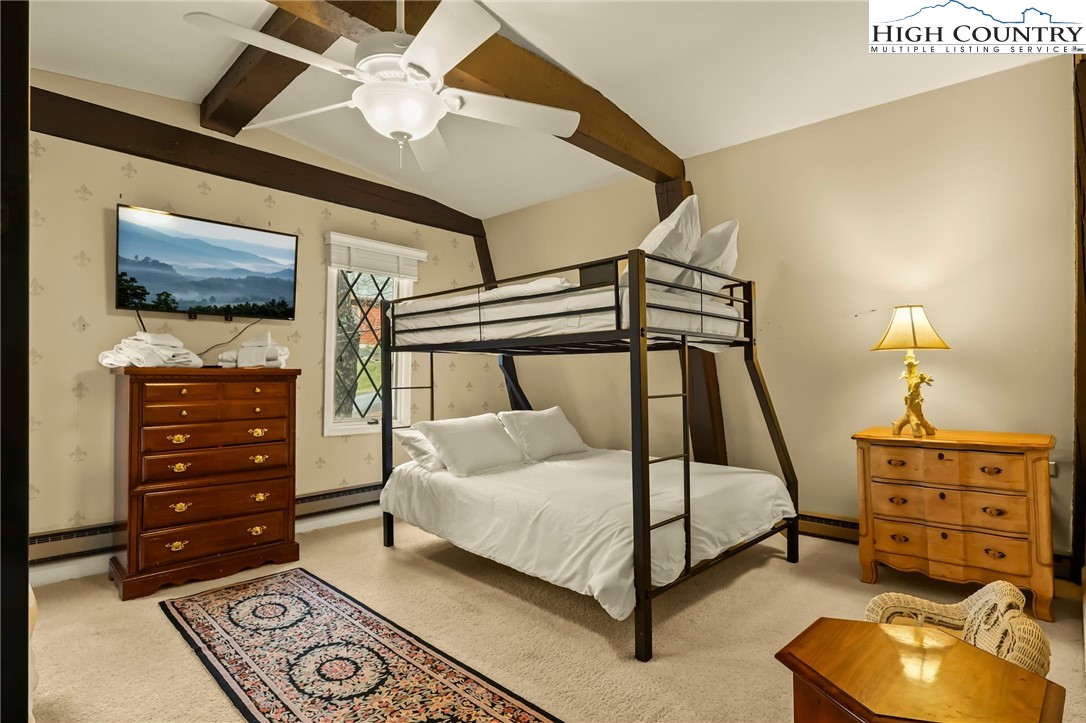 207 Pinnacle Ridge Road Beech Mountain, NC 28604 - Photo 44 of 48 a bedroom with a bed and a flat tv screen on dresser