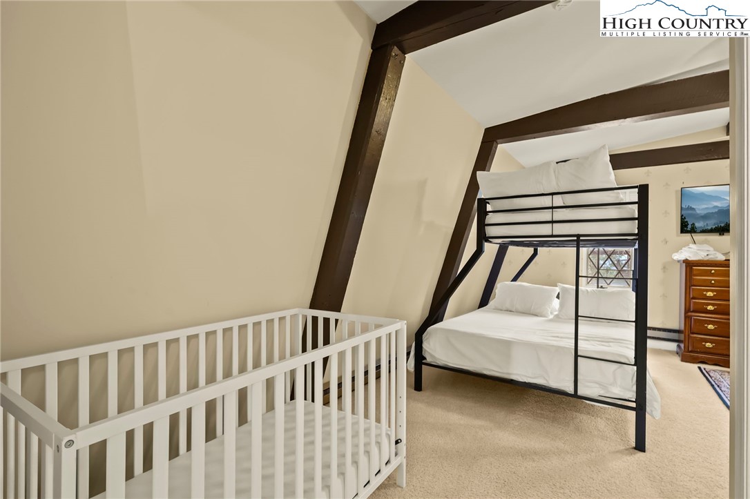 207 Pinnacle Ridge Road Beech Mountain, NC 28604 - Photo 45 of 48 a bedroom with furniture and window