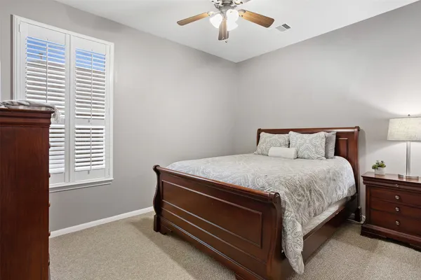 a spacious bedroom with a bed and a chandelier