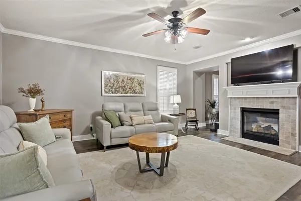 a living room with furniture a flat screen tv and a fireplace
