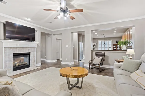 a living room with furniture a flat screen tv and a fireplace