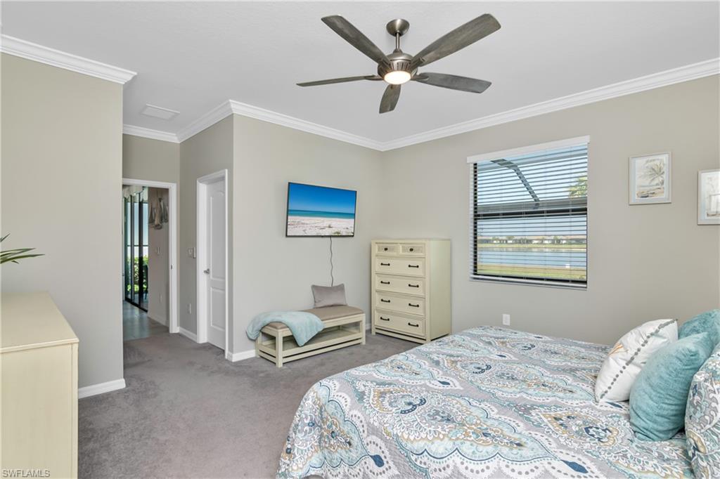 19828 The Pl Boulevard Estero, FL 33928 - Photo 12 of 37 a bedroom with a bed and a chandelier