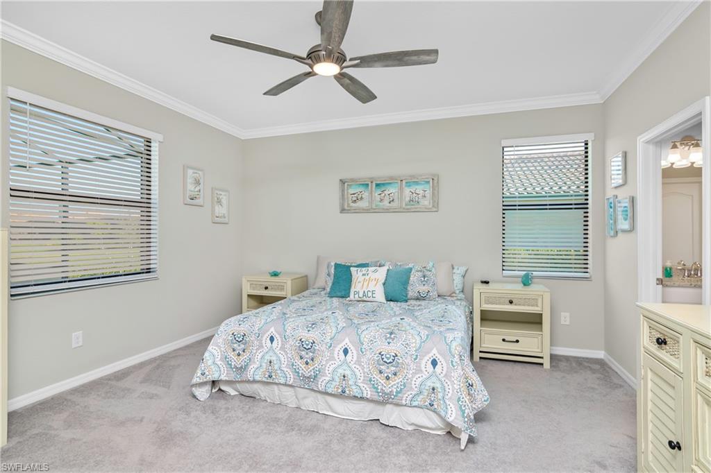 19828 The Pl Boulevard Estero, FL 33928 - Photo 13 of 37 a bedroom with a bed a chandelier and a window