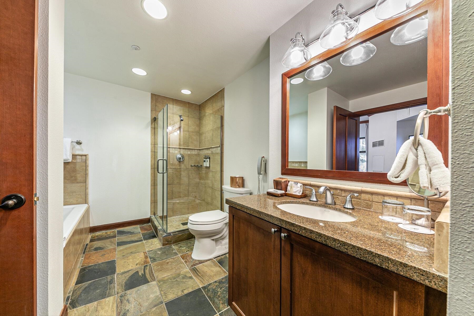 400 Resort Road, Unit 118 120 Olympic Valley, CA 96146 - Photo 11 of 27 a bathroom with a granite countertop sink a toilet a mirror and shower
