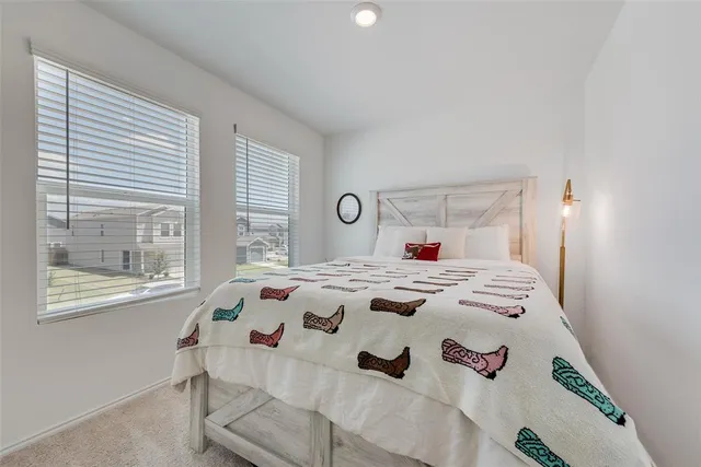 a bedroom that has a bed and a window