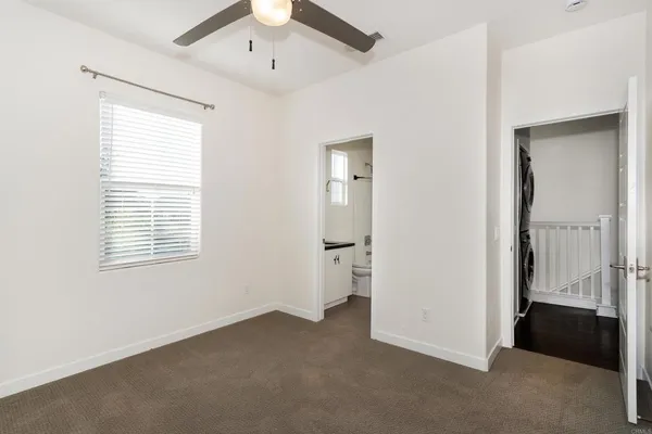 a bathroom with a granite countertop sink toilet a mirror and shower