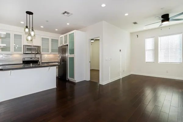 a view of kitchen with refrigerator and window