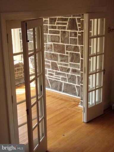 3621 Rexmere Road Baltimore, MD 21218 - Photo 22 of 22 sun room with stone walls and two walls of windows