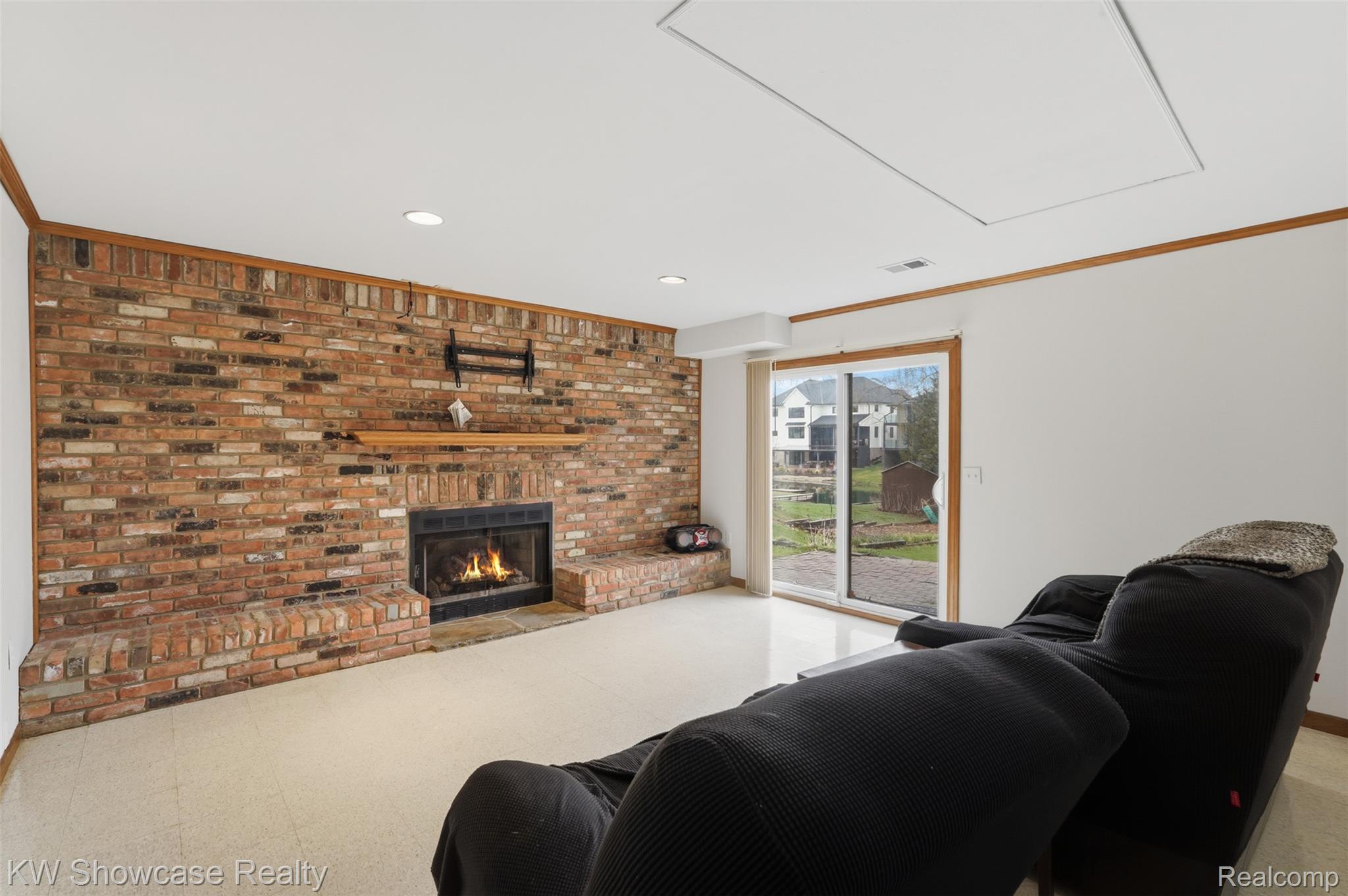3330 Benstein Road Commerce Township, MI 48382 - Photo 15 of 40 LL Living room featuring brick fireplace and recessed lighting