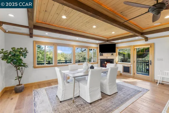 a dining room with furniture window and wooden floor