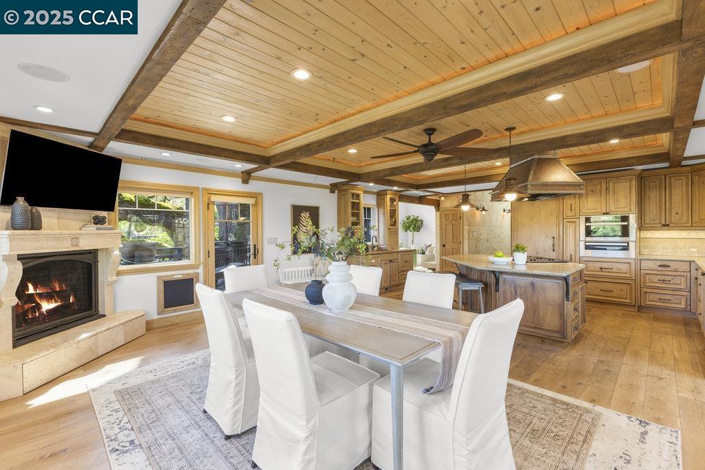 1111 Stone Valley Road Alamo, CA 94507 - Photo 13 of 47 a dining room with furniture a fireplace and wooden floor