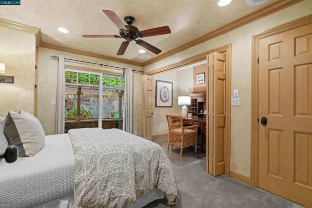 a spacious bedroom with a large bed and a chandelier