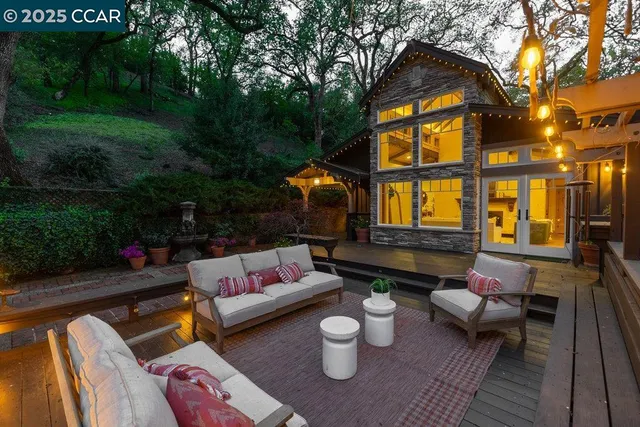 a outdoor living space with furniture and a fireplace