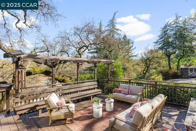 a view of a chairs and table in the balcony
