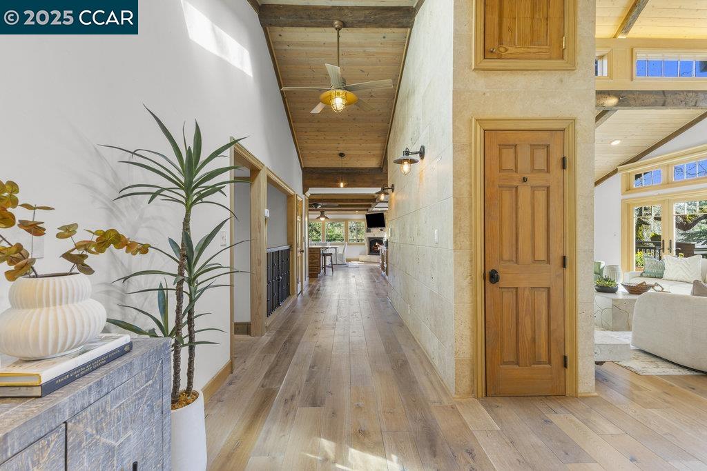 1111 Stone Valley Road Alamo, CA 94507 - Photo 5 of 47 a view of a hallway with wooden floor and a potted plant