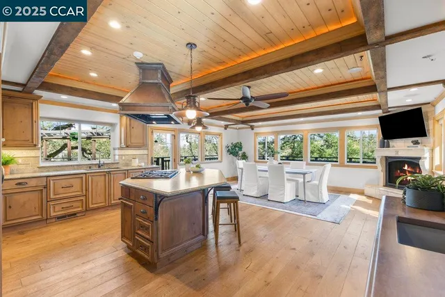a kitchen with a stove and a white cabinets with wooden floor