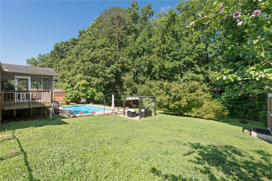 200 Echo Circle Easley, SC 29642 - Photo 30 of 35 A screened porch and refreshing pool complement the expansive, verdant backyard space.