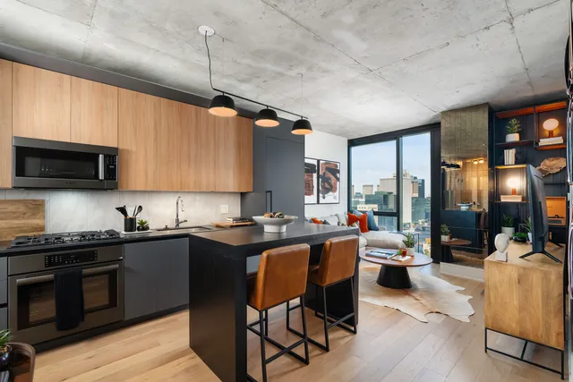 a kitchen with stainless steel appliances granite countertop a sink dishwasher a stove refrigerator and cabinets with wooden floor