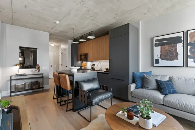 a living room with furniture kitchen view and a fireplace