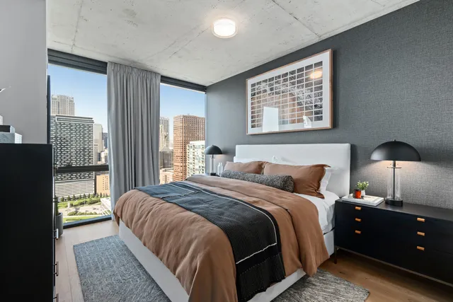 a bedroom with a bed and a lamp