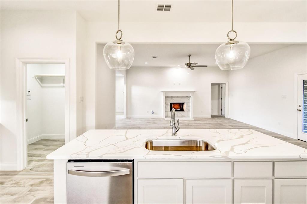 a kitchen with a sink and chandelier