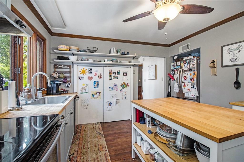 1639 Frazier Road Decatur, GA 30033 - Photo 14 of 30 a room with stainless steel appliances kitchen island a large stove a refrigerator and a dining table