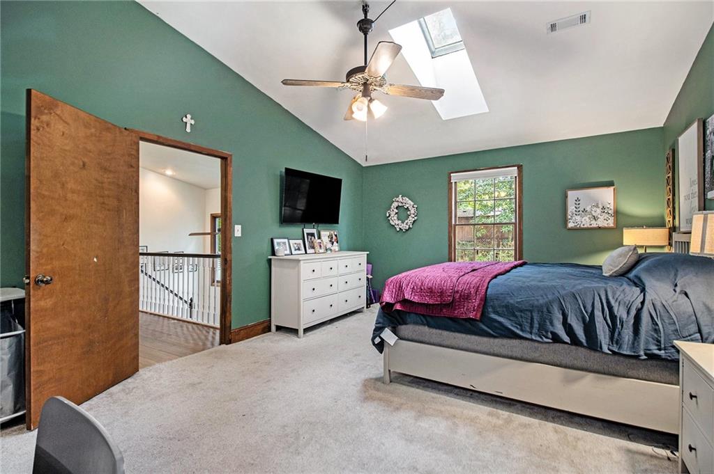 1639 Frazier Road Decatur, GA 30033 - Photo 23 of 30 a spacious bedroom with a bed flat screen tv and a large window