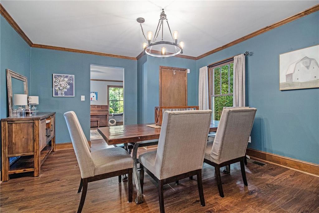 1639 Frazier Road Decatur, GA 30033 - Photo 10 of 30 a dining room with furniture a chandelier and wooden floor