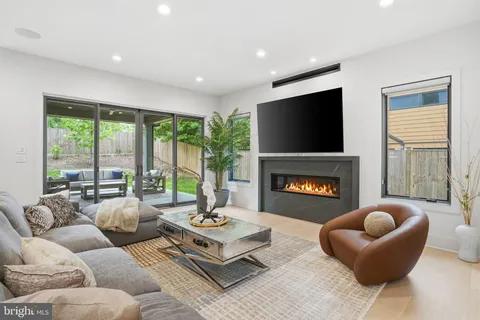 a kitchen with stainless steel appliances granite countertop a sink a stove and a wooden floors