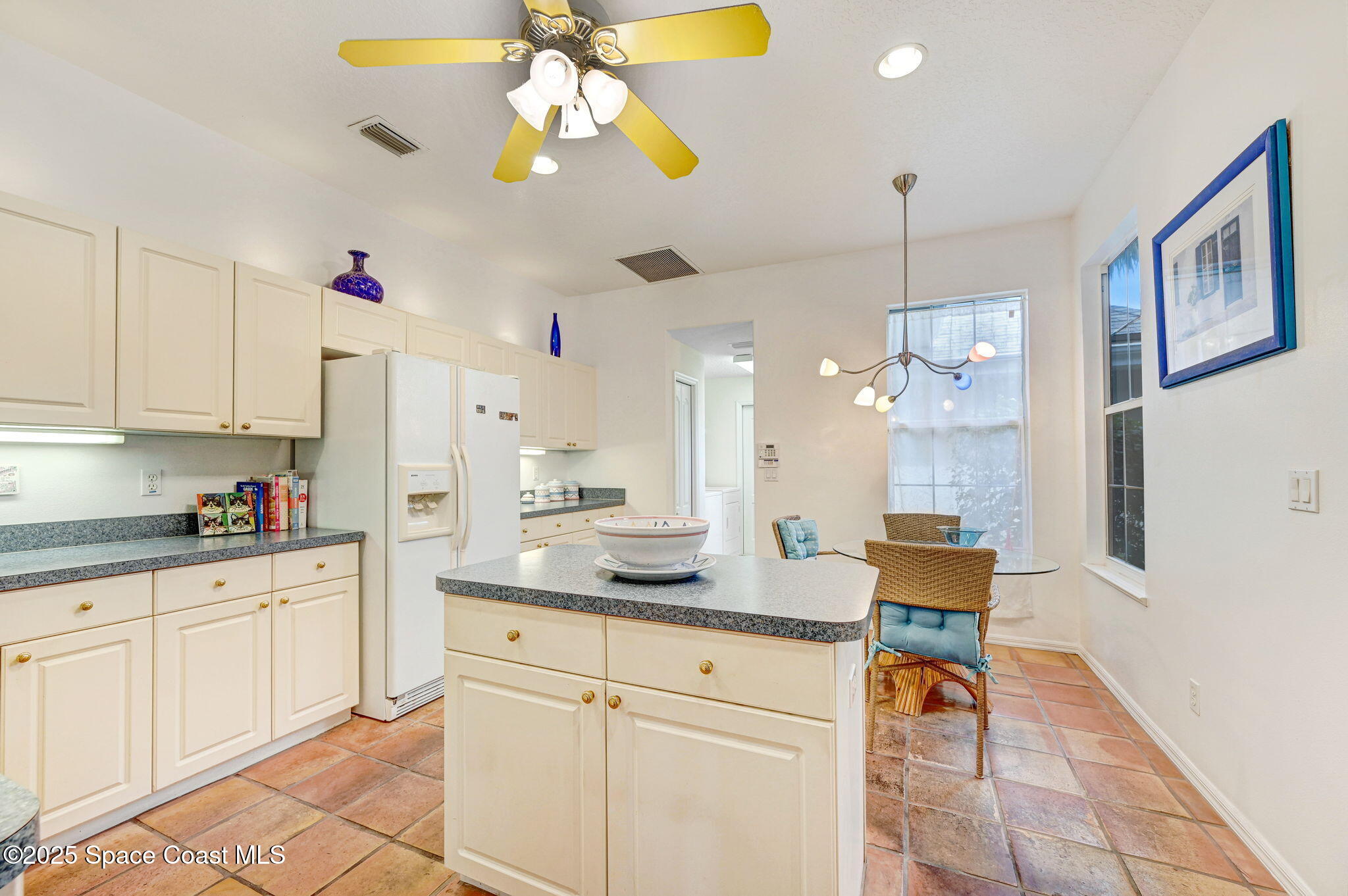 4341 Aberdeen Circle Rockledge, FL 32955 - Photo 12 of 43 a kitchen with granite countertop white cabinets stainless steel appliances and dining table