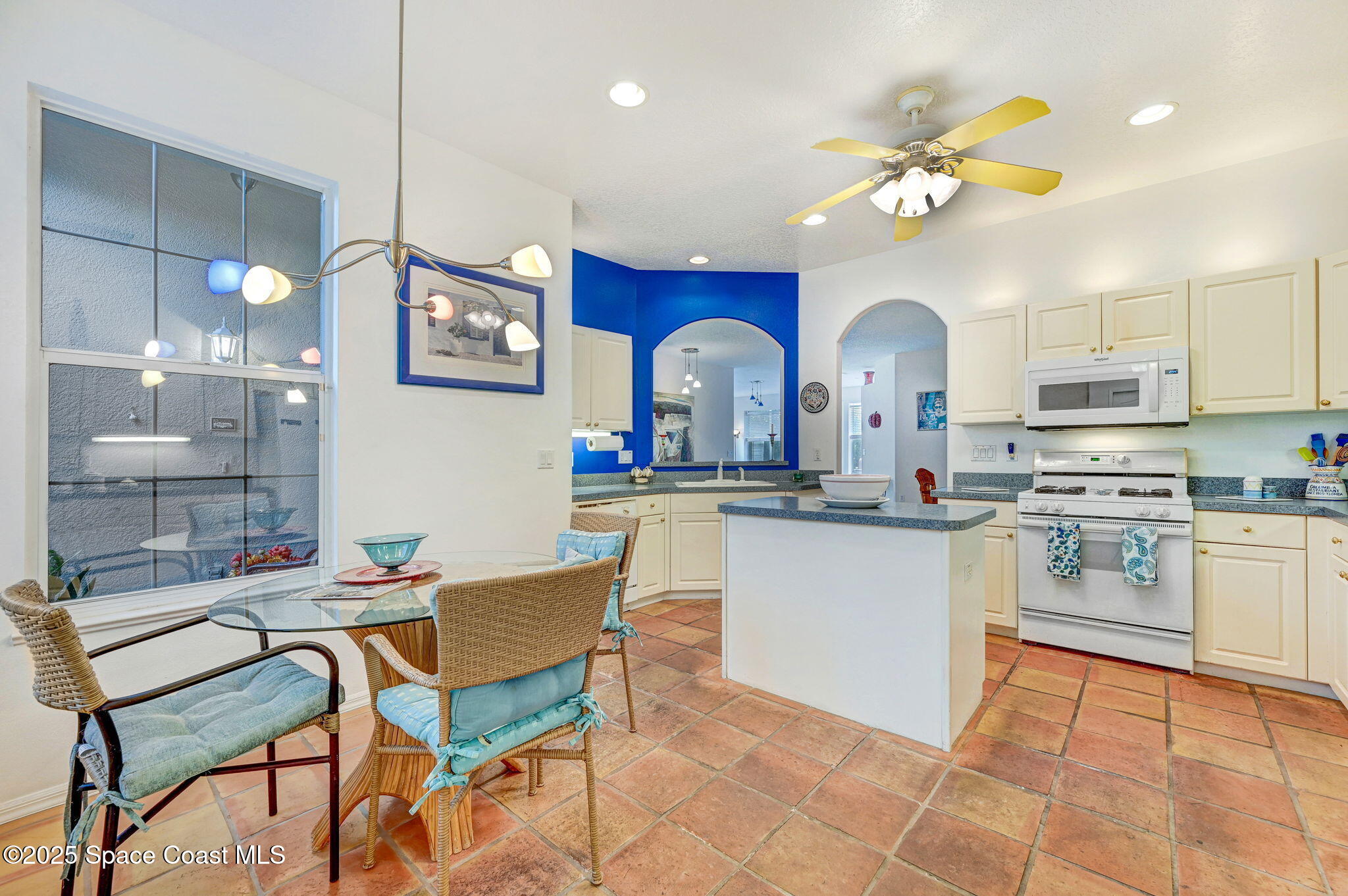 4341 Aberdeen Circle Rockledge, FL 32955 - Photo 13 of 43 a kitchen with stainless steel appliances a dining table chairs sink and stove top oven