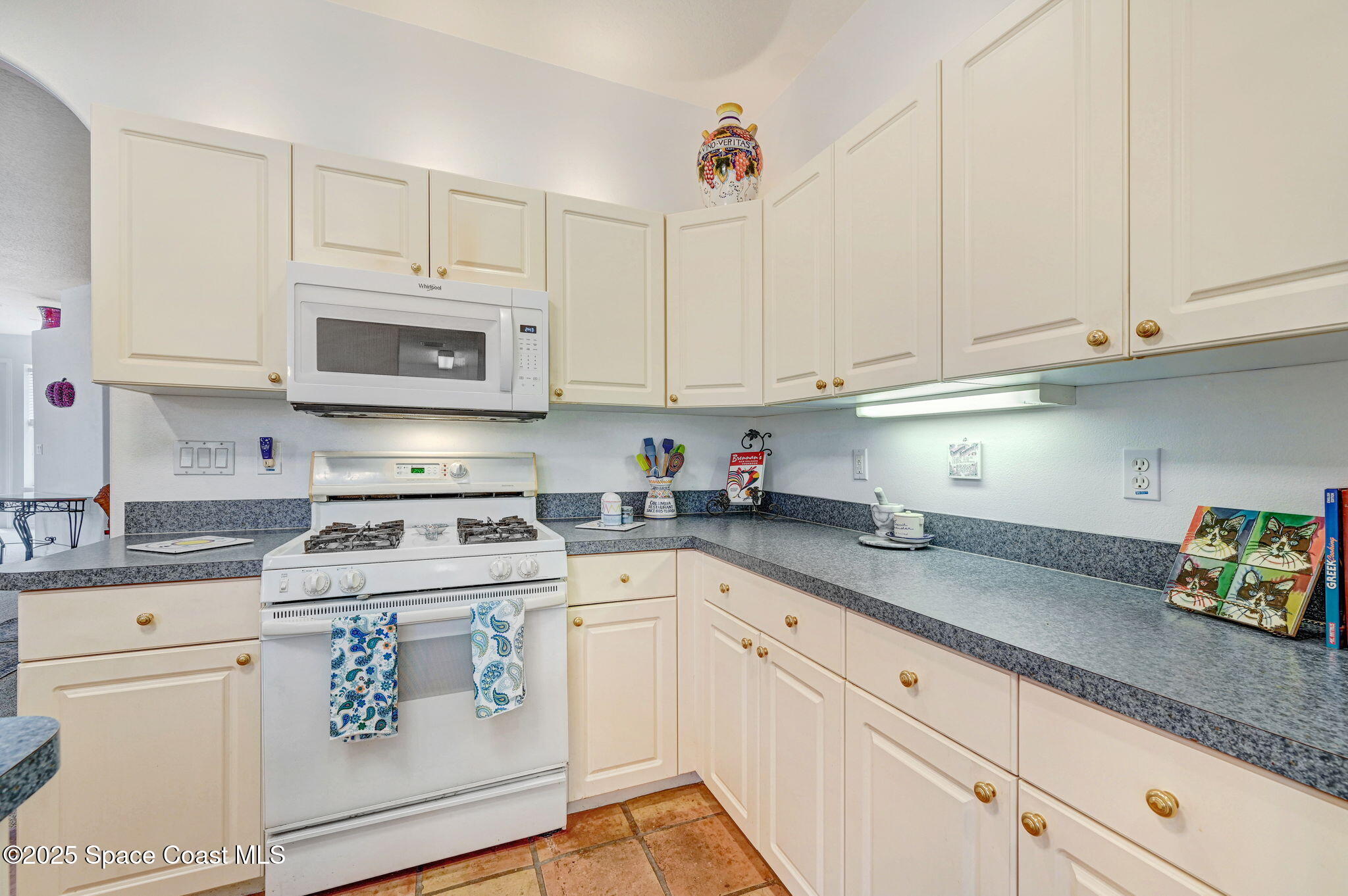 4341 Aberdeen Circle Rockledge, FL 32955 - Photo 16 of 43 a kitchen with cabinets appliances a sink and a counter top space