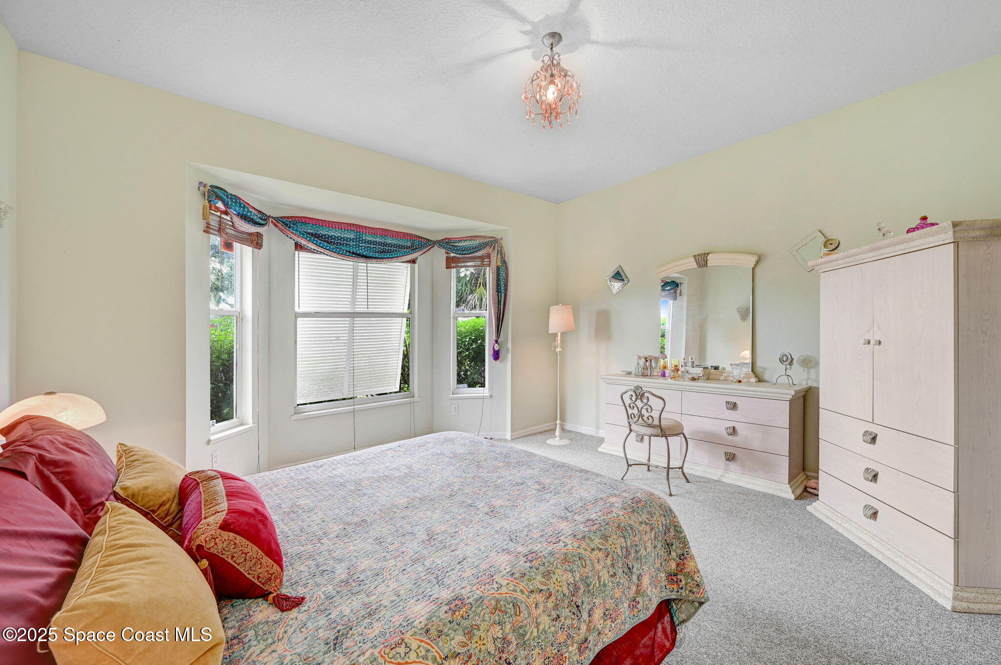4341 Aberdeen Circle Rockledge, FL 32955 - Photo 23 of 43 a bedroom with a bed and a chandelier