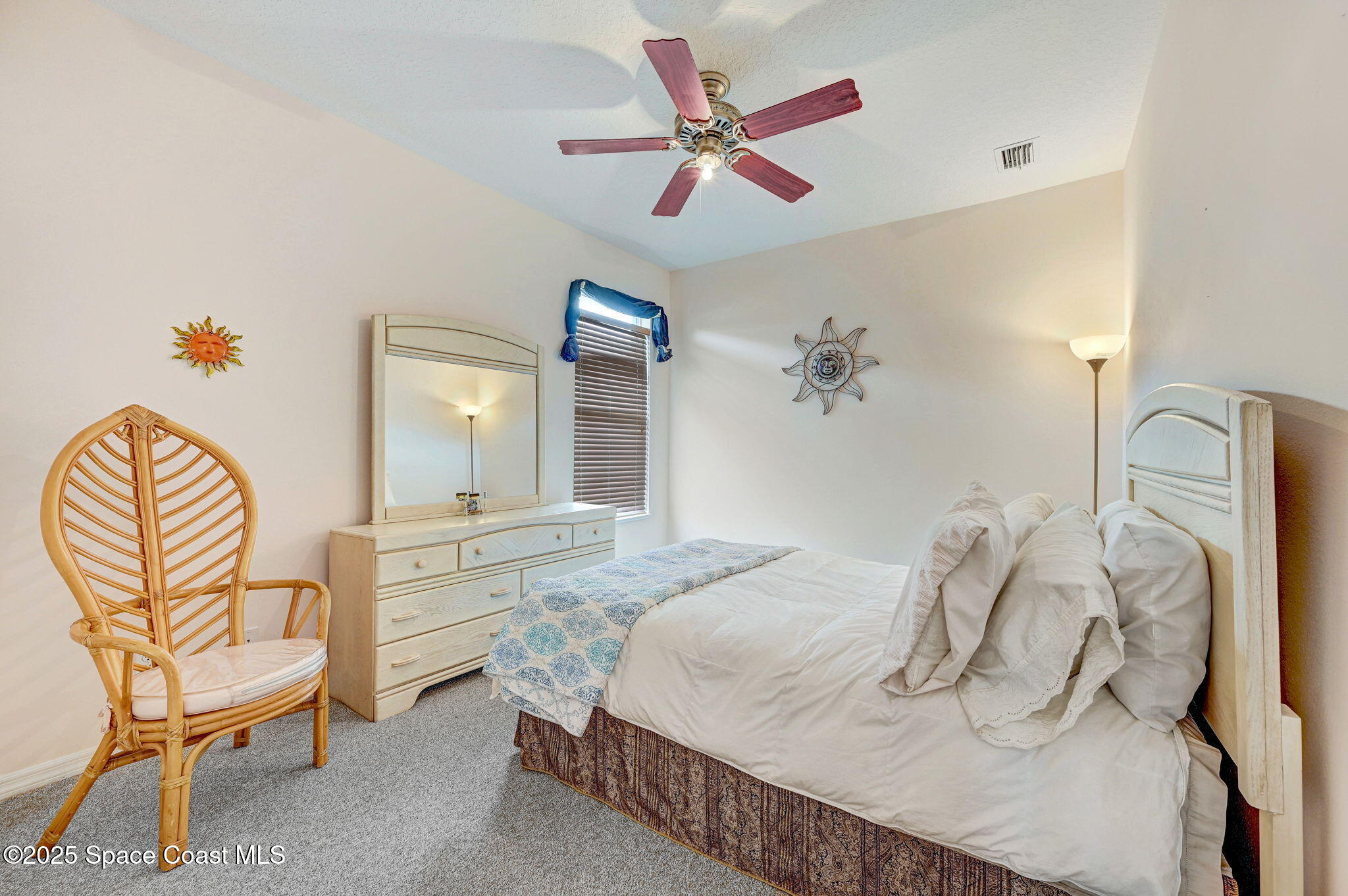 4341 Aberdeen Circle Rockledge, FL 32955 - Photo 28 of 43 a bedroom with a bed and a chair