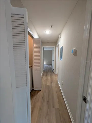 a view of hallway with wooden floor