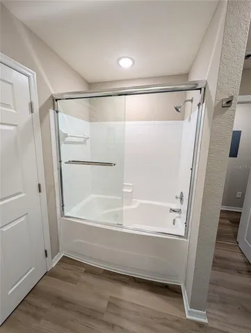 a bathroom with a glass shower door