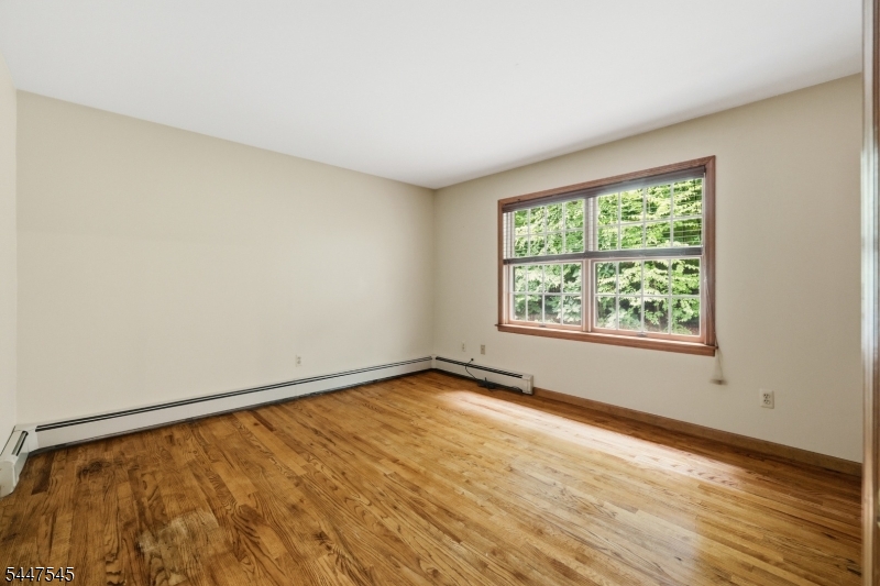 860 Glen Road Sparta, NJ 07871 - Photo 28 of 43 an empty room with wooden floor and windows