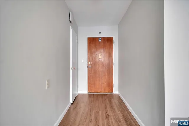 a view of a hallway with wooden floor