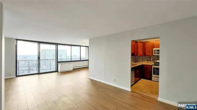 a view of kitchen and hall with wooden floor