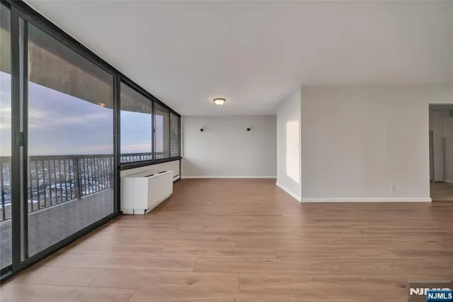 a view of kitchen with stainless steel appliances wooden floor