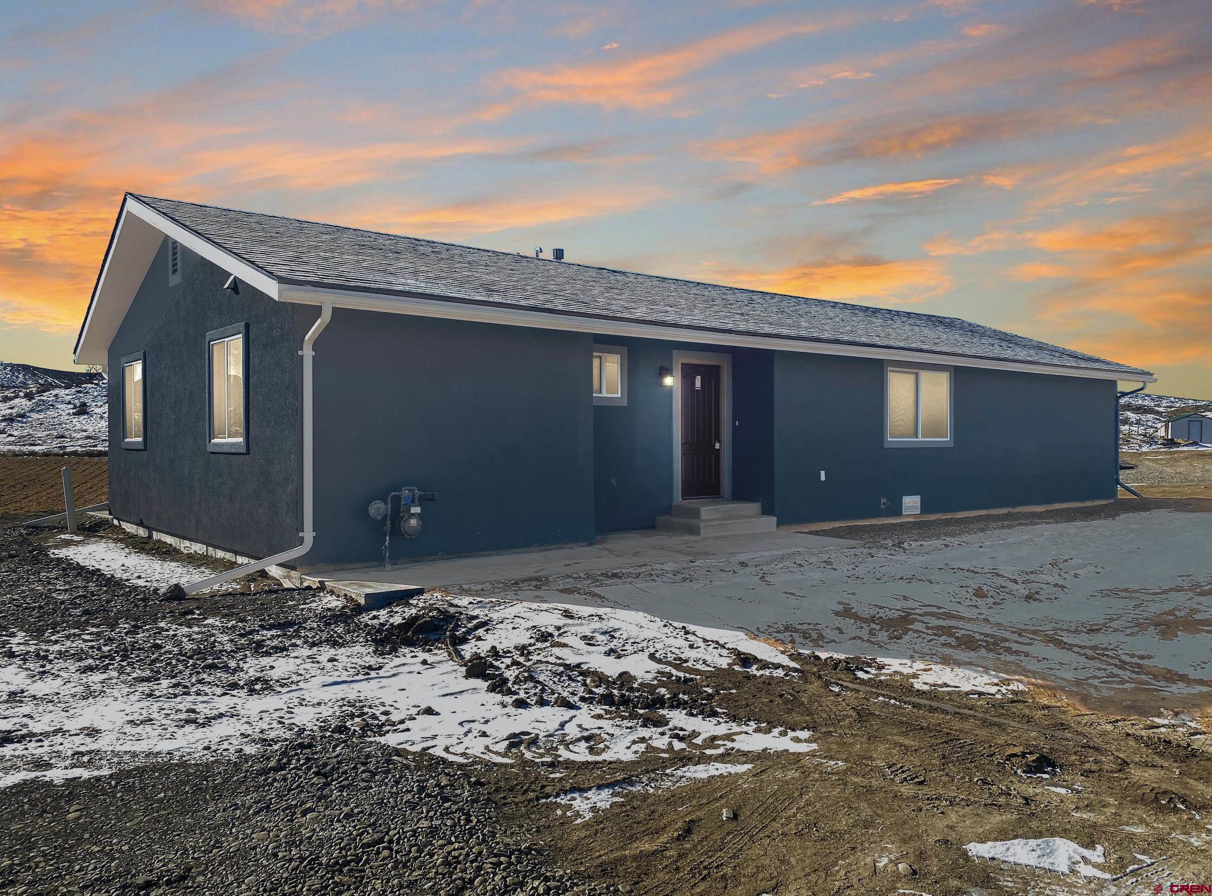 a view of a house with a backyard
