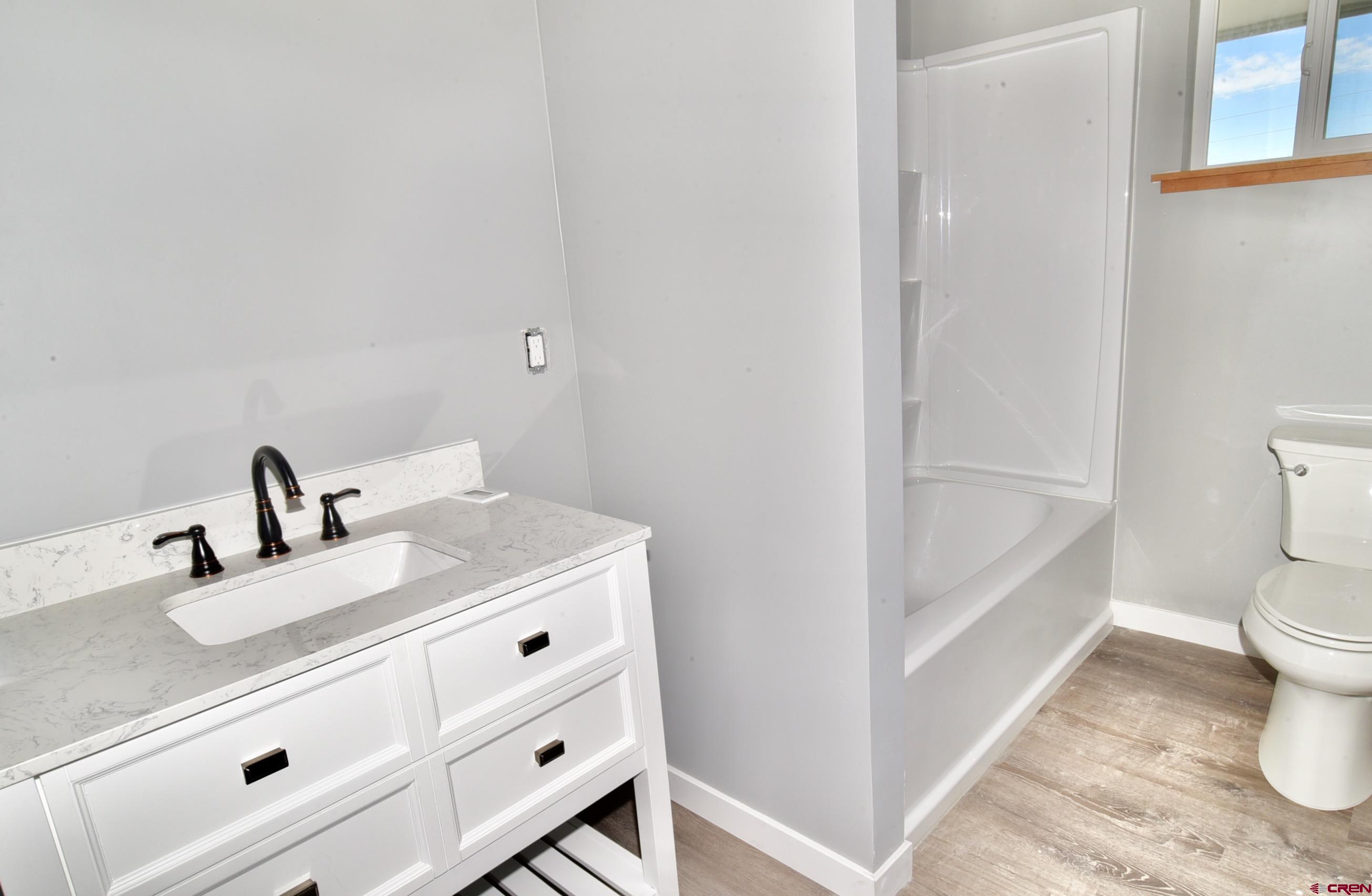 66462 Landfill Road Montrose, CO 81401 - Photo 27 of 30 a bathroom with a sink a toilet and vanity