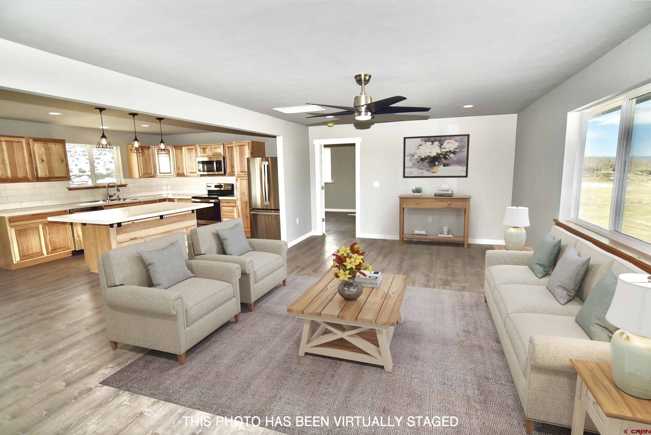 66462 Landfill Road Montrose, CO 81401 - Photo 5 of 30 a living room with furniture and view of kitchen